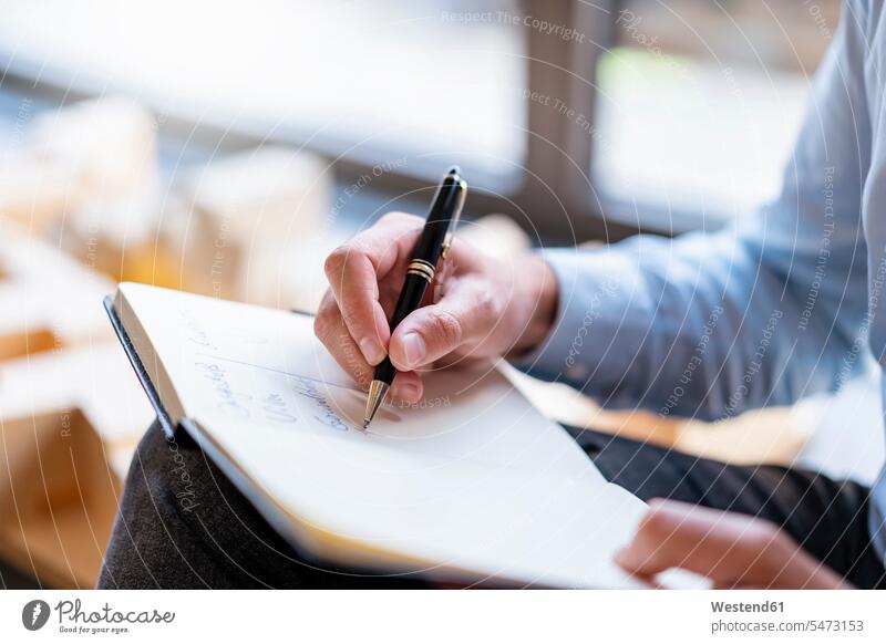 Close-up of businessman taking notes in office human human being human beings humans person persons caucasian appearance caucasian ethnicity european 1
