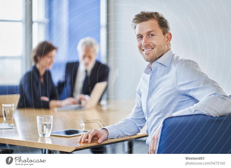 Portrait of smiling businessman during a meeting in office human human being human beings humans person persons caucasian appearance caucasian ethnicity