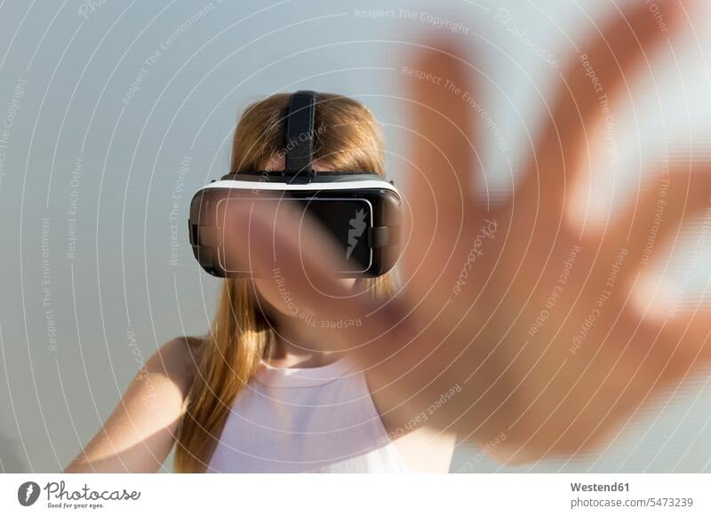 Young woman using Vr googles, reaching with her hand play Distinct individual Visions young culture location shot location shots outdoor outdoor shot