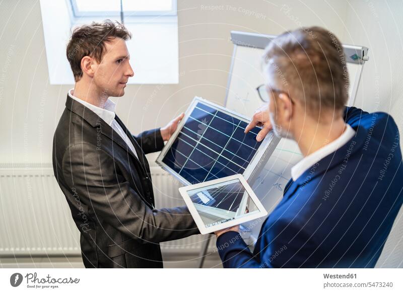 Two businessmen in office with solar cell and tablet discussing discussion digitizer Tablet Computer Tablet PC Tablet Computers iPad Digital Tablet