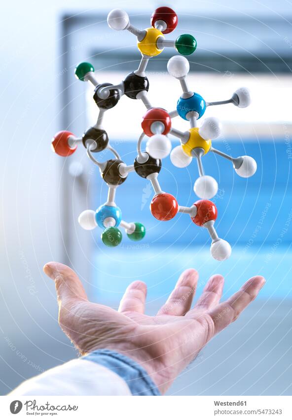 Hand and a floating molecular model, gravity science sciences scientific hand human hand hands human hands weightless weightlessness chemistry