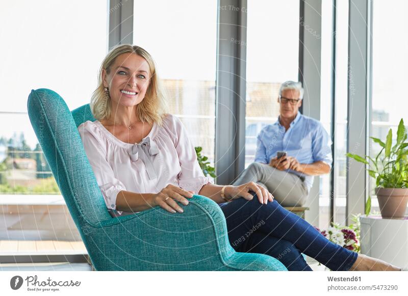 Portrait of mature couple relaxing at home relaxed relaxation window windows portrait portraits twosomes partnership couples people persons human being humans