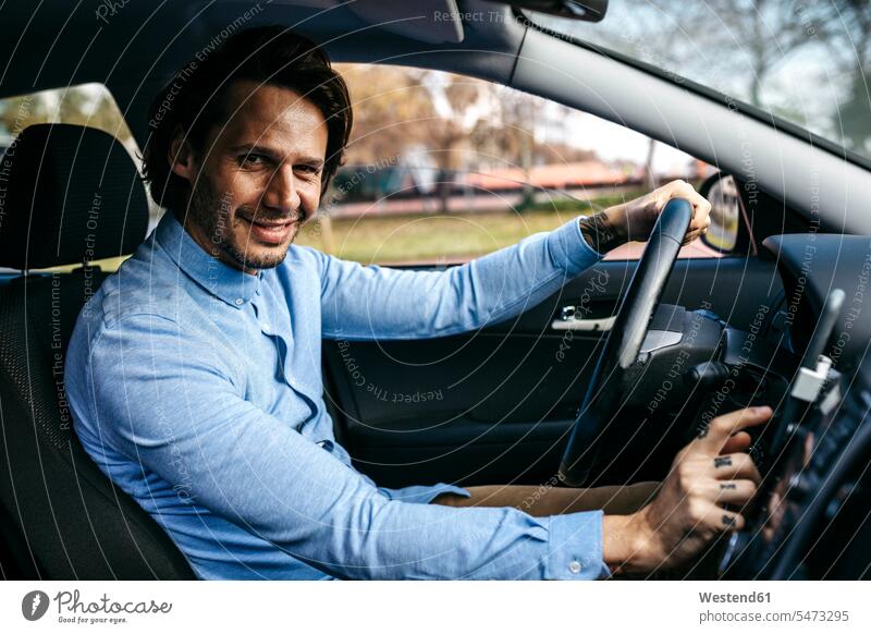 Portrait of smiling businessman driving car using cell phone as navigation system Businessman Business man Businessmen Business men route guidance system drive