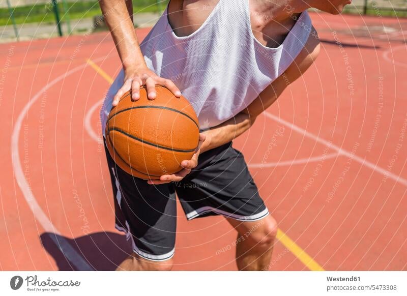 Young man playing basketball copy space Ambition ambitious moving move Motivation Incentive motivating Motivations sunlight Sunlit agility agile individuality