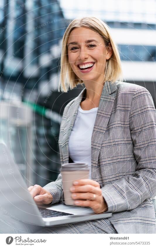 Portrait of happy young businesswoman with laptop in the city Occupation Work job jobs profession professional occupation business life business world