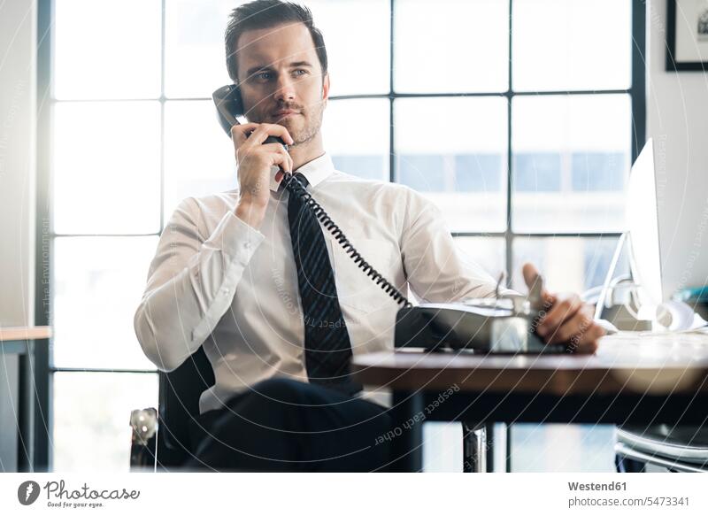 Businessman in office using vintage retro telephone retro style Retro-Styled Retro Styled retro revival telephones offices office room office rooms Business man
