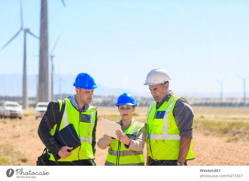 Three engineers with tablet discussing on a wind farm discussion wind park digitizer Tablet Computer Tablet PC Tablet Computers iPad Digital Tablet