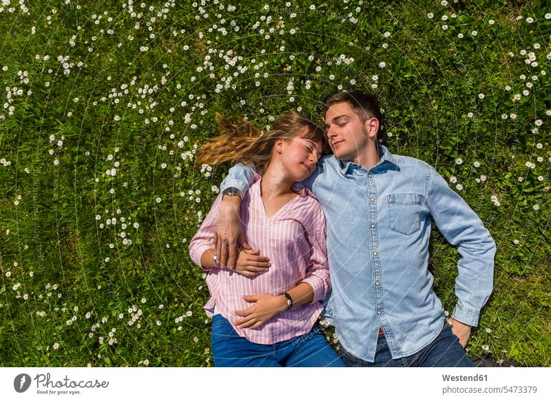 Happy young couple relaxing on grass in a park, overhead view summer summer time summery summertime getting away from it all Getting Away From All unwinding