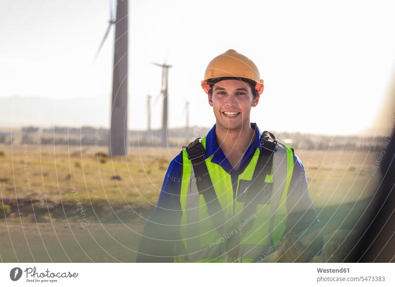 Portrait of smiling technician on a wind farm wind park smile portrait portraits technicians wind power plant wind turbine wind turbines wind energy