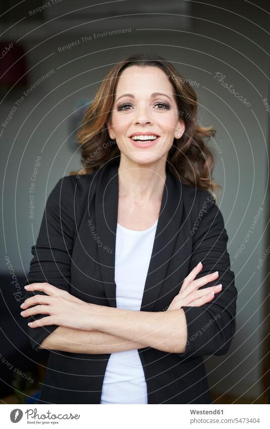 Portrait of happy businesswoman with arms crossed business life business world business person businesspeople business woman business women businesswomen smile