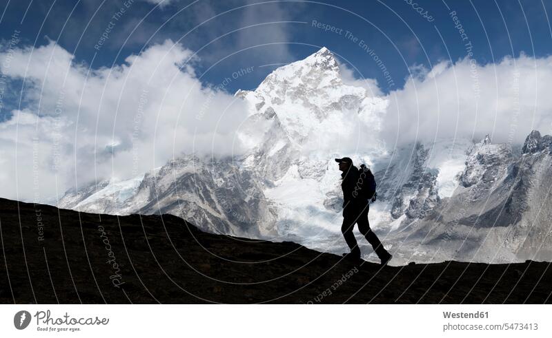 Woman trekking with Mt Everest, Nuptse and Kala Patthar in background, Himalayas, Solo Khumbu, Nepal human human being human beings humans person persons