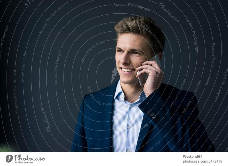 Portrait of smiling young businessman on cell phone mobile phone mobiles mobile phones Cellphone cell phones portrait portraits on the phone call telephoning