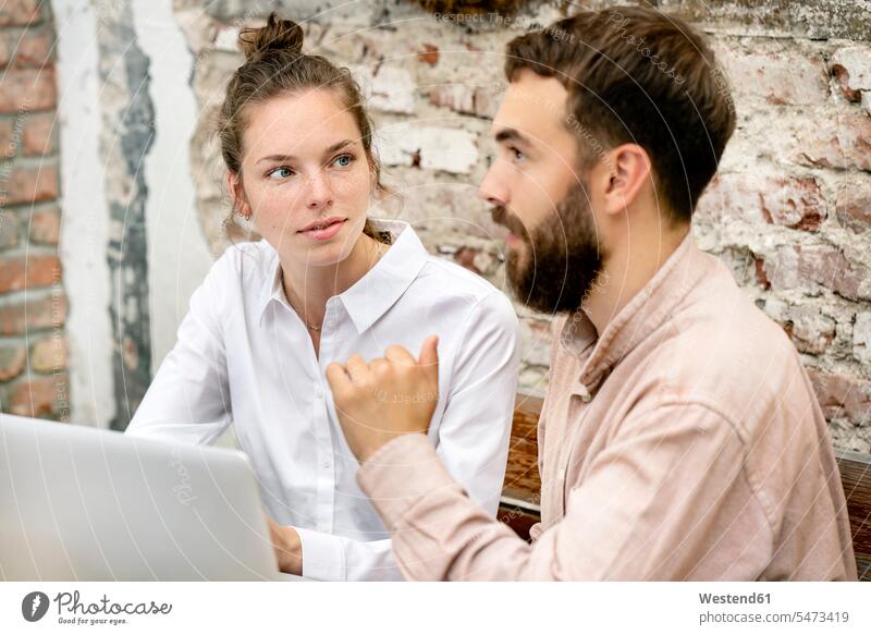 Young couple working in backyard, using laptop human human being human beings humans person persons caucasian appearance caucasian ethnicity european 2 2 people