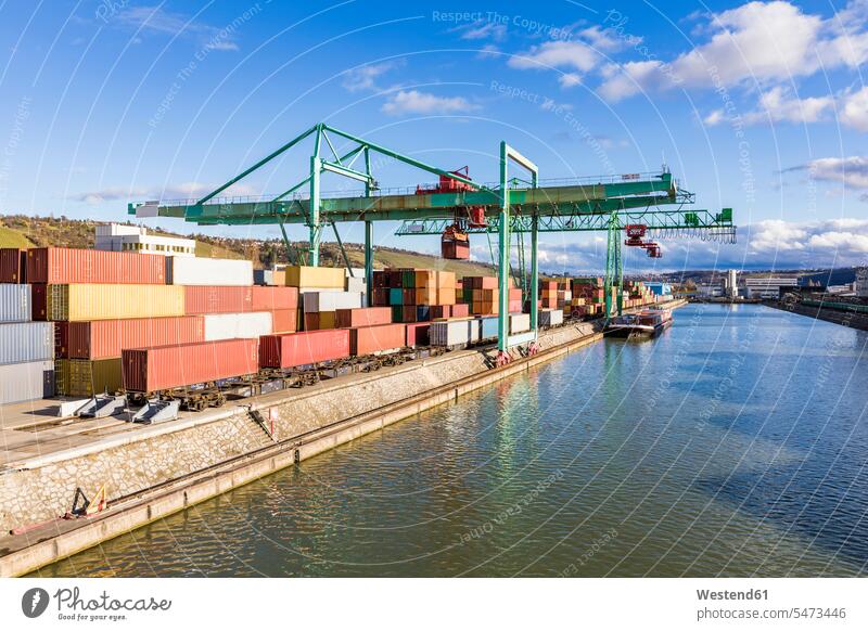 Germany, Baden-Wurttemberg, Stuttgart, Cargo containers stacked in commercial dock on bank of Neckar river outdoors location shots outdoor shot outdoor shots