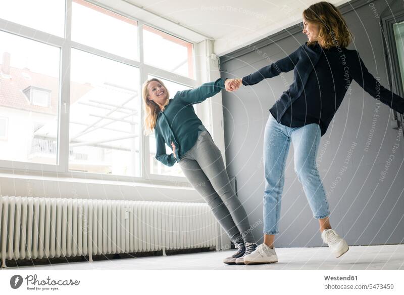 Two young women supporting each other playfully human human being human beings humans person persons caucasian appearance caucasian ethnicity european 2