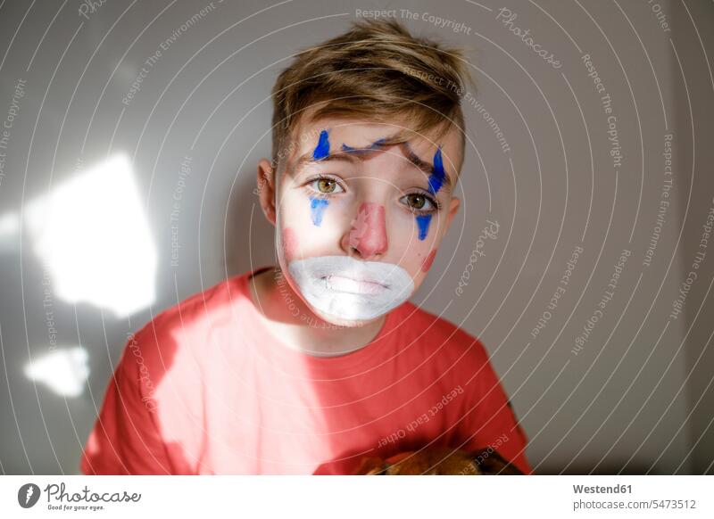 Portrait of sad boy made up as a clown portrait portraits boys males clowns child children kid kids people persons human being humans human beings