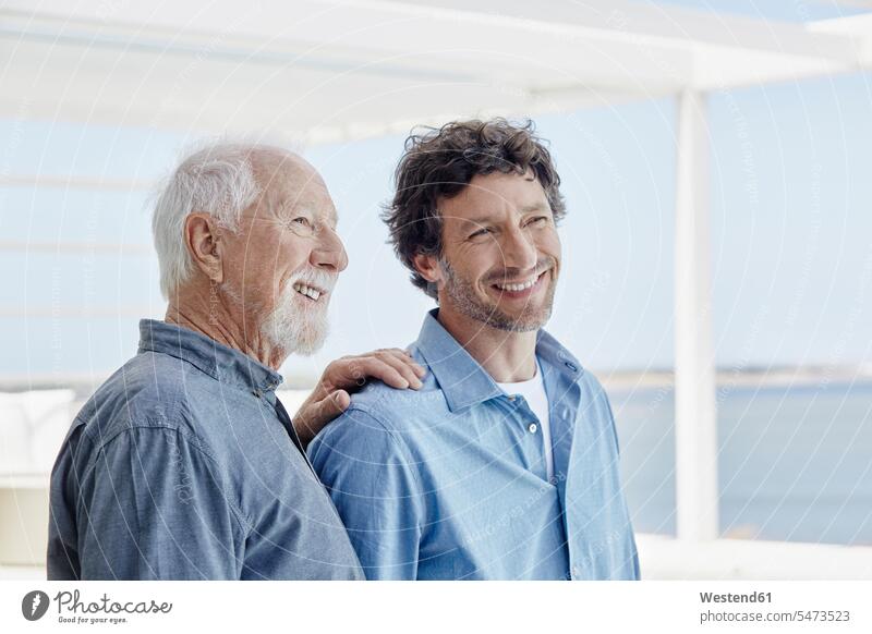 Portrait of confident senior man with adult son at a beach house human human being human beings humans person persons caucasian appearance caucasian ethnicity