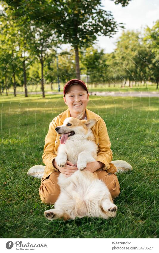 Boy with Welsh Corgi Pembroke in a park human human being human beings humans person persons caucasian appearance caucasian ethnicity european 1 one person only