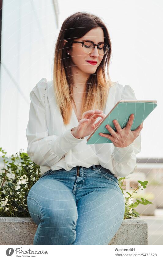 Portrait of smiling young businesswoman using digital tablet outdoors human human being human beings humans person persons caucasian appearance