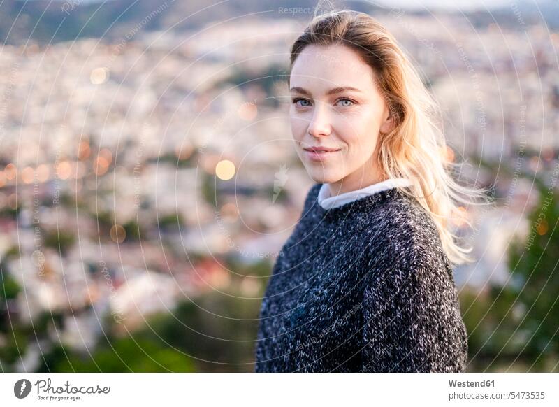 Portrait of young woman at sunrise above the city, Barcelona, Spain human human being human beings humans person persons caucasian appearance