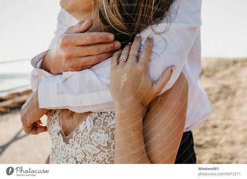 Close-up of affectionate bride and groom hugging outdoors human human being human beings humans person persons caucasian appearance caucasian ethnicity european