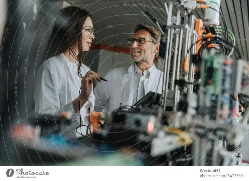 Colleagues discussing about machinery in laboratory color image colour image indoors indoor shot indoor shots interior interior view Interiors scientist science
