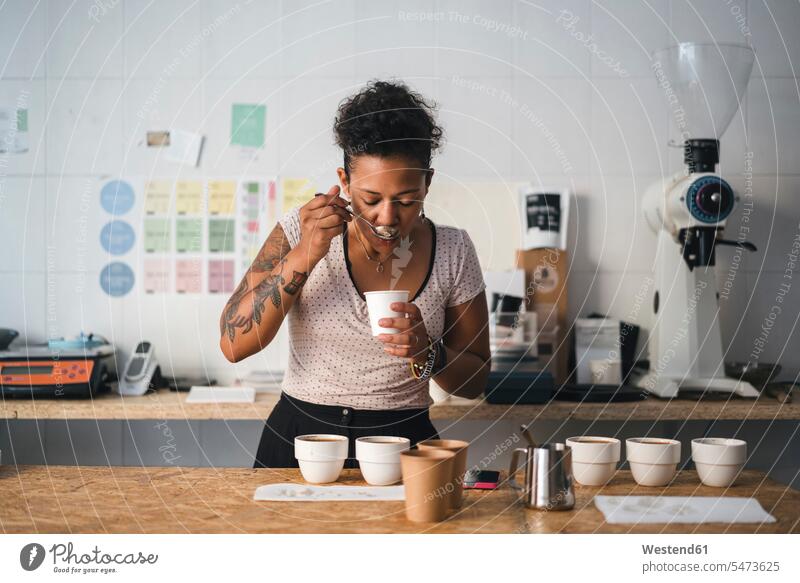 Woman working in a coffee roastery tasting product human human being human beings humans person persons Mixed Race mixed race ethnicity mixed-race Person 1