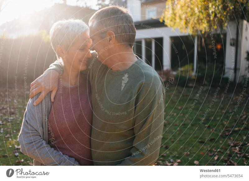 Affectionate senior couple embracing in garden outdoor location shots outdoor shot outdoor shots house home residential home Residential Building