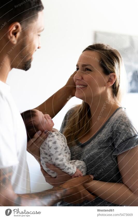 Happy parents holding newborn baby at home father fathers daddy dads papa happiness happy eyes closed closed eyes Eyes Shut Care caring care together positive