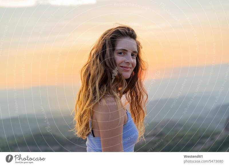 Woman watching sunset in the mountains smiling smile woman females women Catalonia observing observe sunsets sundown mountain range mountain ranges Adults