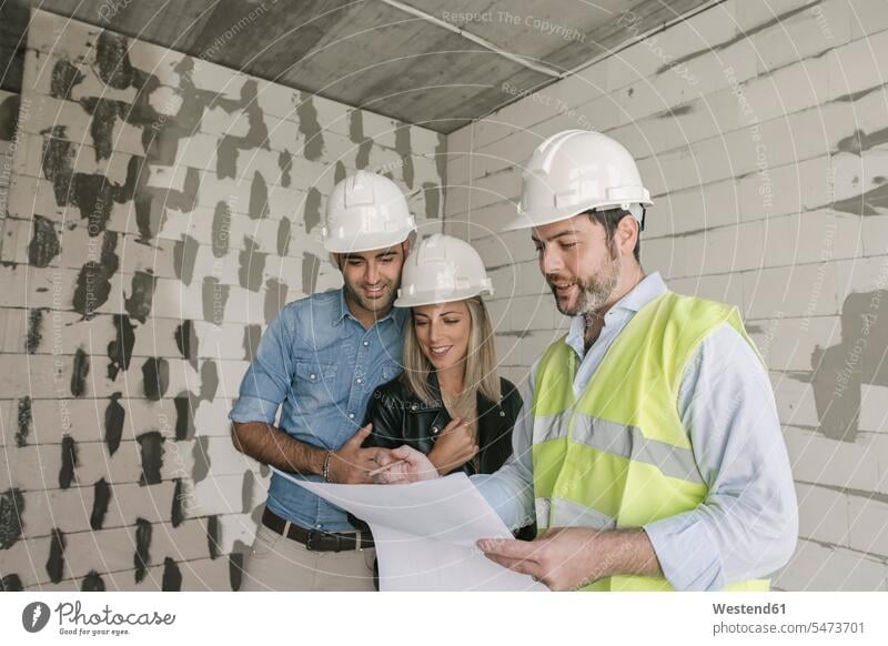 Architect talking about architectural plan with future owners on construction site Occupation Work job jobs profession professional occupation architects maps