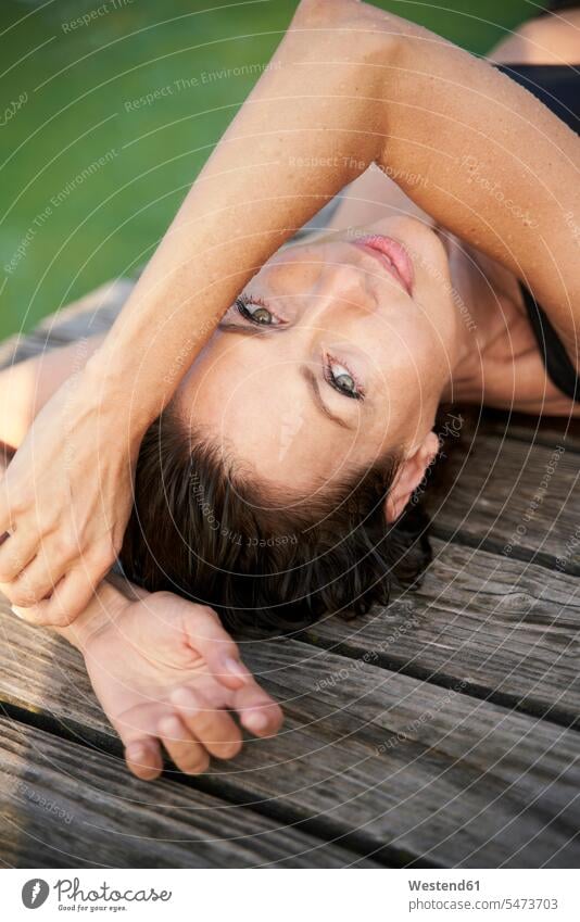 Portait of mature woman lying on a jetty at a lake human human being human beings humans person persons caucasian appearance caucasian ethnicity european 1