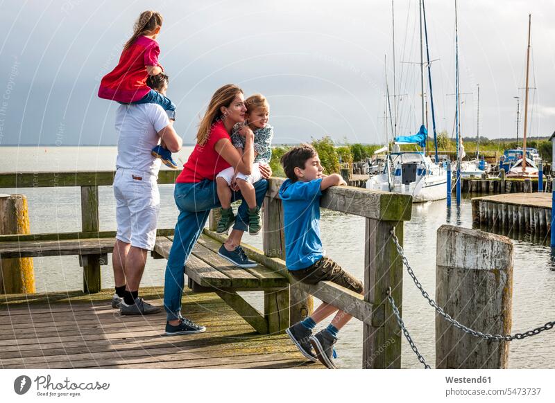 Family standing on a pier looking at view, Ahrenshoop, Mecklenburg-Western Pomerania, Germany human human being human beings humans person persons Mixed Race