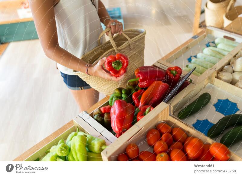 Young woman in organic store choosing vegetables human human being human beings humans person persons Asian Asians Japanese 1 one person only only one person