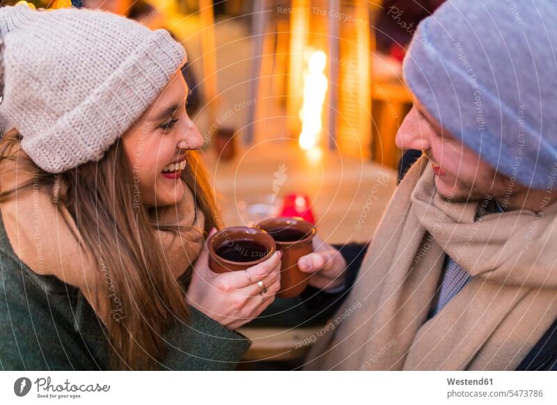 Happy young couple drinking mulled wine at Christmas market happiness happy twosomes partnership couples Mulled Wine Mulled Claret Event Events people persons