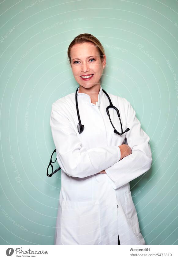 Portrait of smiling female doctor with stethoscope woman females women Female Doctor physicians Female Doctors smile portrait portraits Adults grown-ups