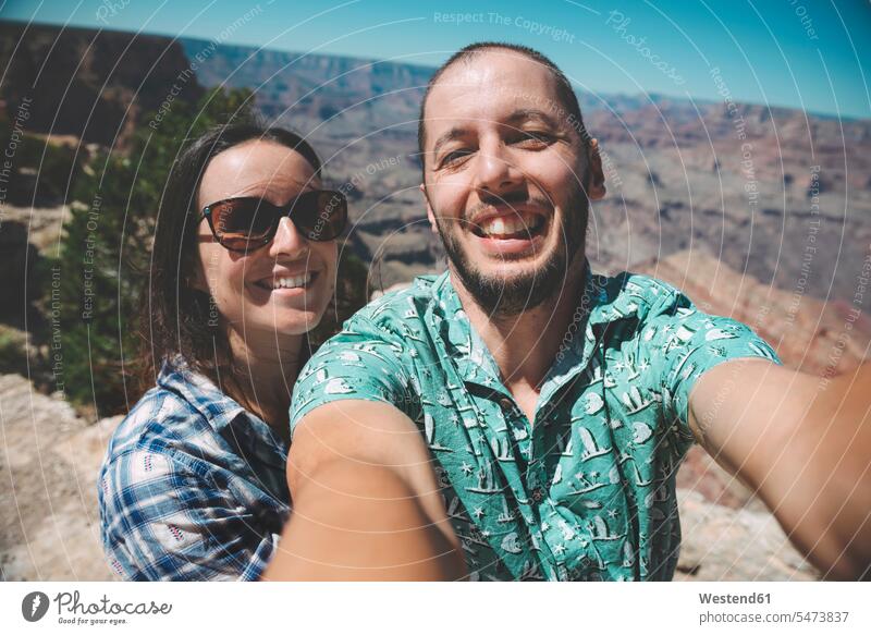 USA, Arizona, Grand Canyon National Park, happy couple taking a selfie Selfie Selfies happiness twosomes partnership couples people persons human being humans