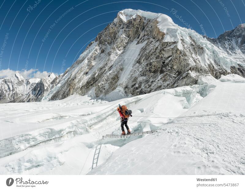 Nepal, Solo Khumbu, Everest, Sagamartha National Park, Mountaineer crossing icefall at Western Cwm balancing balance Himalayas mountaineering Everest region