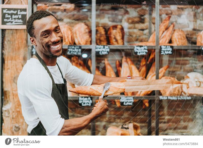 Man working in a bakery human human being human beings humans person persons African black black ethnicity coloured African American African American Ethnicity