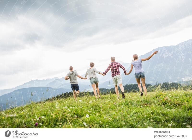 Friends running on a meadow in the mountains, Achenkirch, Austria friends mate relax relaxing Ardor Ardour enthusiasm enthusiastic excited delight enjoyment