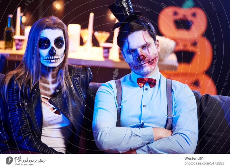 Portrait of spooky couple at Halloween party friends Boredom boring bored hooded Party Parties All Hallows' Eve celebrating celebrate partying friendship