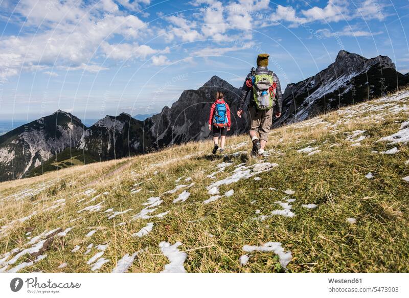 Austria, Tyrol, young couple hiking in the mountains mountain range mountain ranges hike twosomes partnership couples landscape landscapes scenery terrain