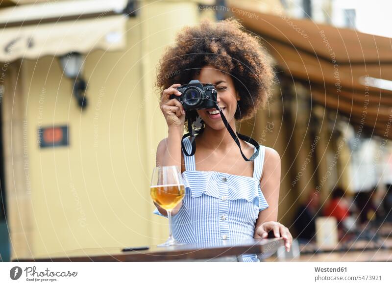 Young woman taking photo with camera outdoors photographing females women cameras Adults grown-ups grownups adult people persons human being humans human beings