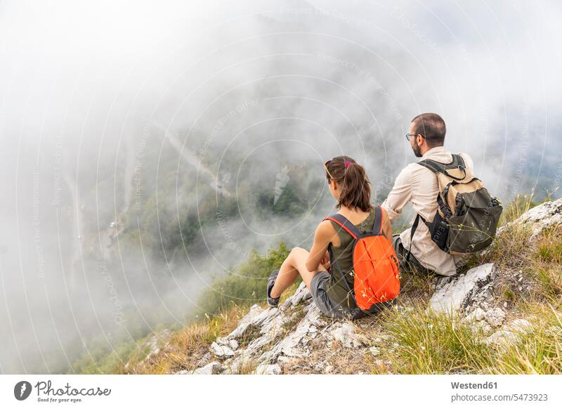 Italy, Massa, couple looking at the beautiful view in the Alpi Apuane hiking hike seeing viewing sitting Seated mountain mountains View Vista Look-Out outlook