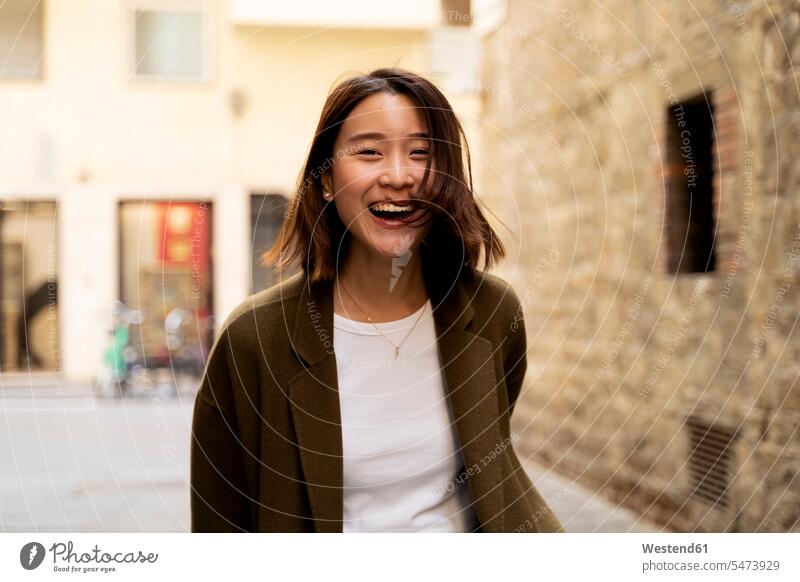 Italy, Florence, happy young woman in the city Asian Ethnicity Asians enjoying indulgence enjoyment savoring indulging happiness Fun having fun funny exuberance