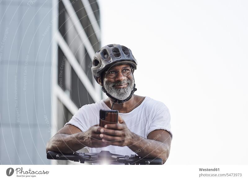 Portrait of happy mature man wearing cycling helmet leaning on handlebar of Electric Scooter T- Shirt t-shirts tee-shirt telecommunication phones telephone