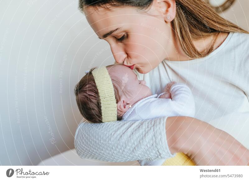Close-up of mother kissing her daughter indoors human human being human beings humans person persons caucasian appearance caucasian ethnicity european 2