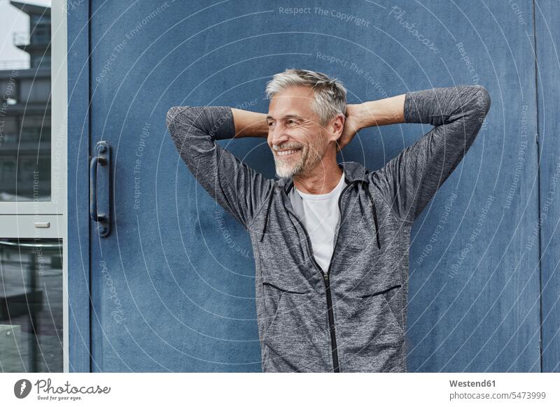 Portrait of laughing mature man in front of gym portrait portraits men males gyms Health Club Laughter Adults grown-ups grownups adult people persons