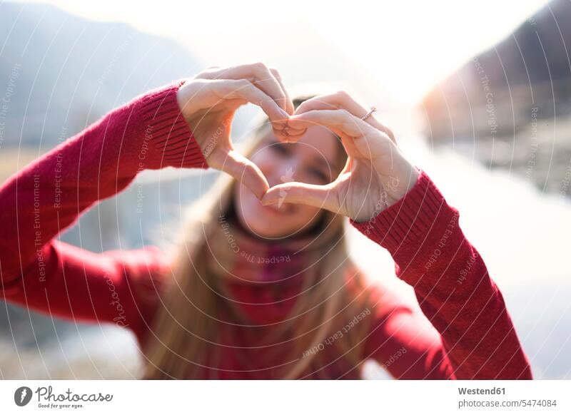 Portrait of young woman making heart shape with hands and fingers human human being human beings humans person persons caucasian appearance caucasian ethnicity