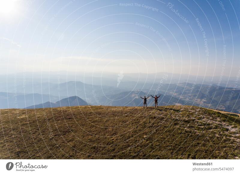 Italy, Monte Nerone, two hikers on top of a mountain enjoying the view hiking man men males mountains indulgence enjoyment savoring indulging wanderers View